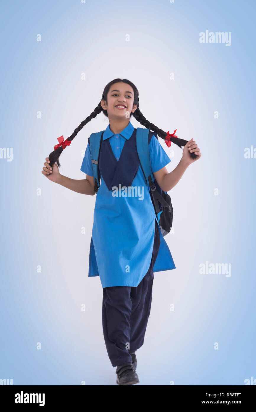 Portrait de jeune fille en uniforme scolaire rural livre sac et portefeuille Banque D'Images