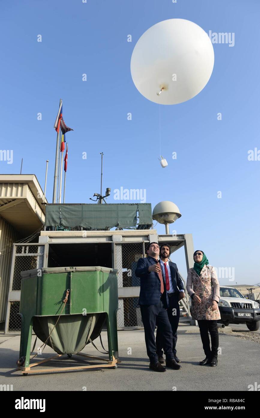 Trois météorologues afghans relâcher un ballon météo à l'Aéroport International d'Hamid Karzaï au cours d'une cérémonie qui marque leur intégration à l'office de météorologie de l'OTAN, à Kaboul, Afghanistan, 1 janvier, 2017. Au total, 10 météorologues Afghans vont rejoindre le bureau afin de renforcer les capacités d'un de l'aéroport par des fonctions essentielles pour les opérations. (L'OTAN Banque D'Images