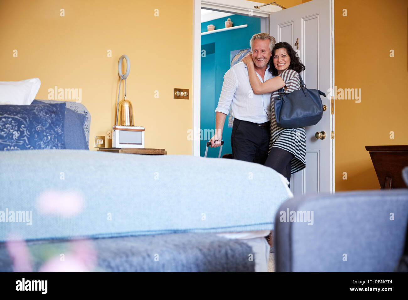 Middle aged couple hugging in la porte d'une chambre d'hôtel Banque D'Images