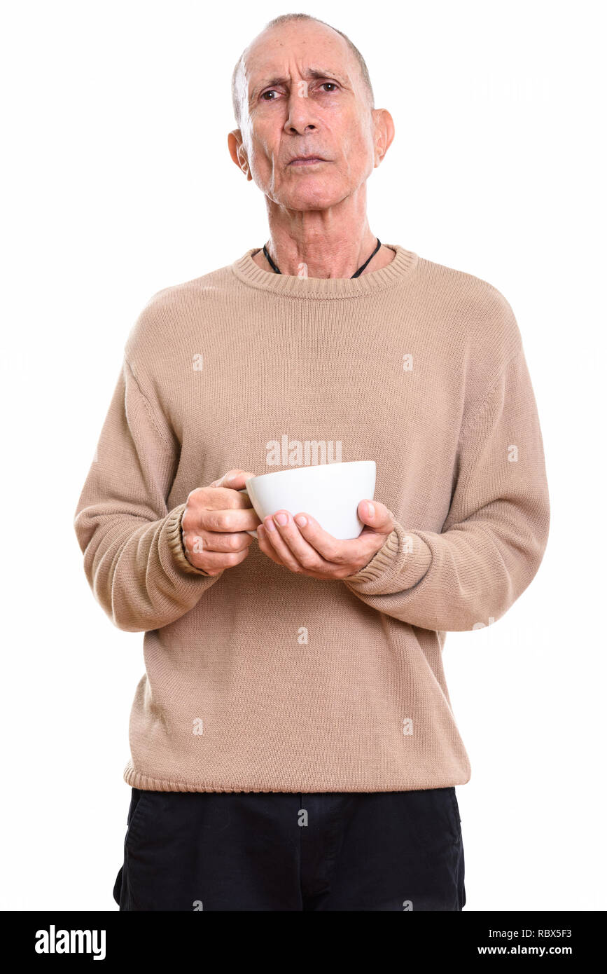Studio shot of angry man holding Coffee cup Banque D'Images