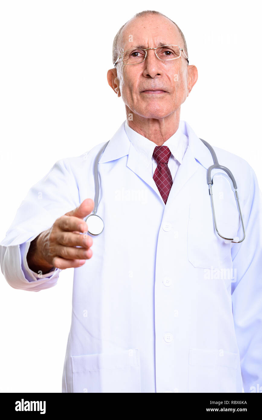 Studio shot of senior woman doctor giving handshake Banque D'Images