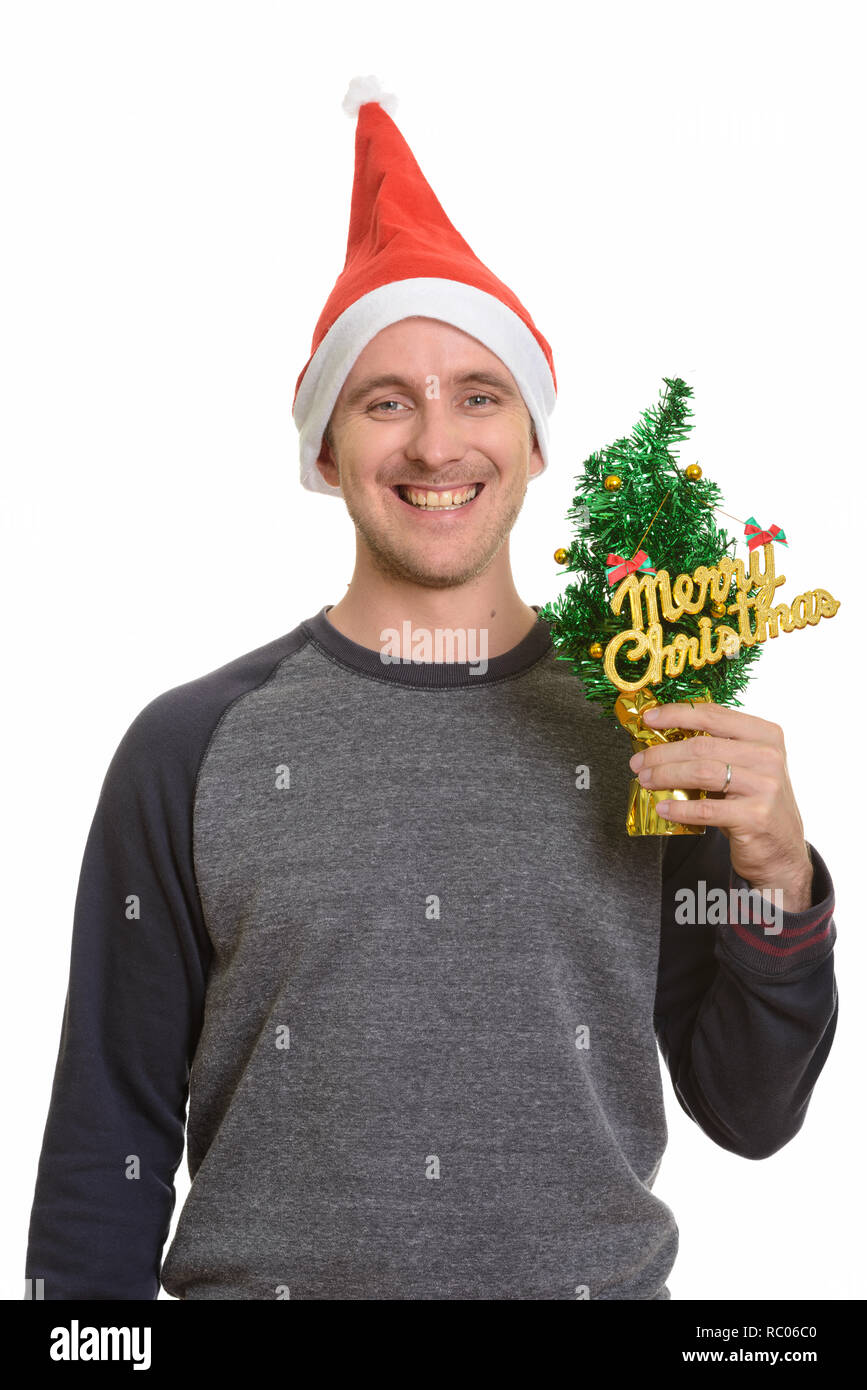 Happy Man holding Merry Christmas Tree Banque D'Images