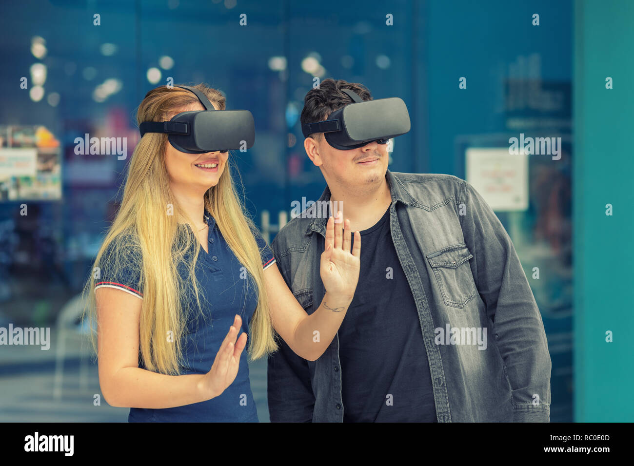 Jeune couple dans l'amour d'une connexion via des lunettes de réalité virtuelle à l'aire de centre - Les jeunes s'amusant à l'aide de la technologie VR nouveau - Amis testi Banque D'Images