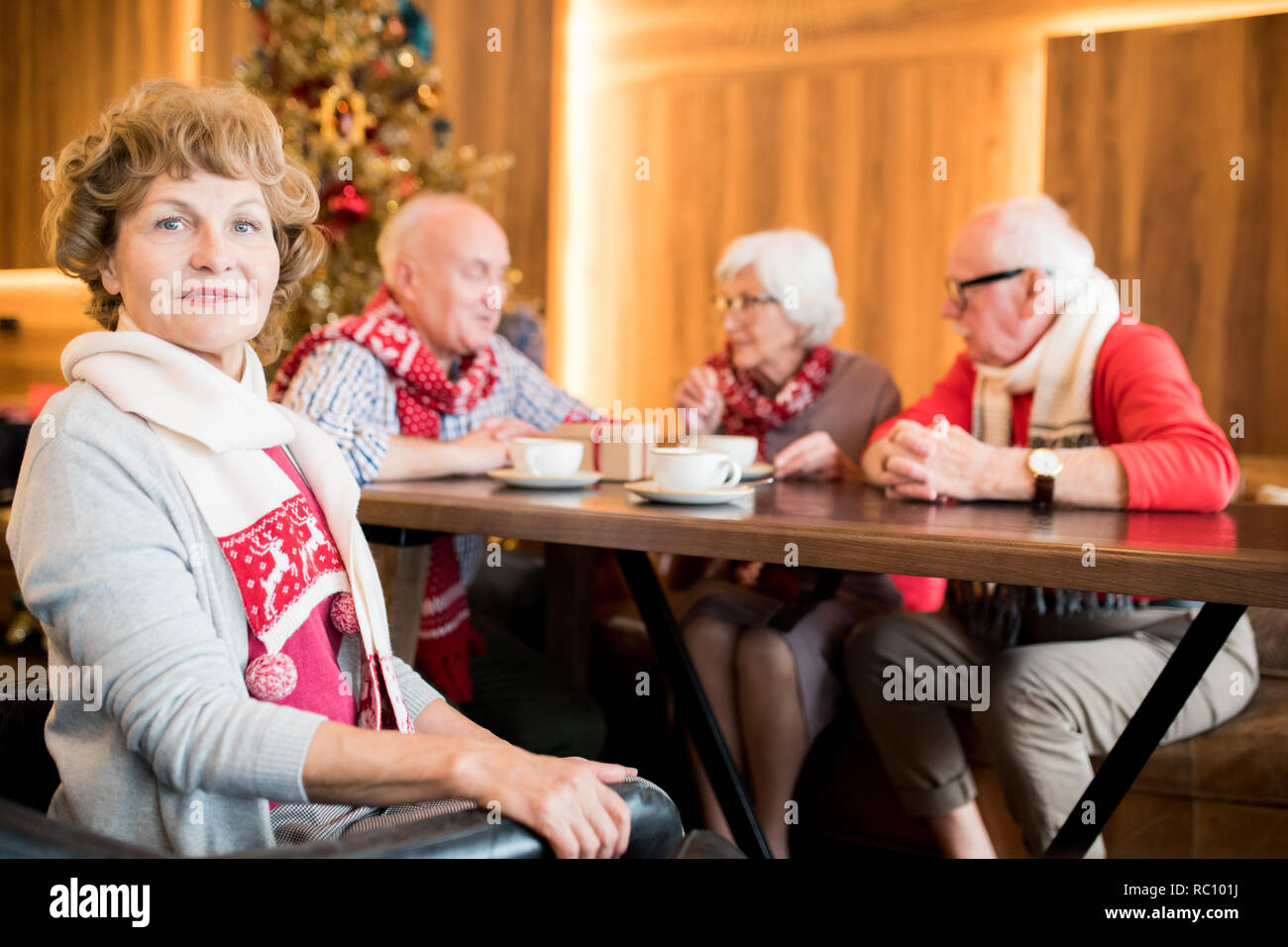 Senior lady contenu dans le café avec des amis Banque D'Images