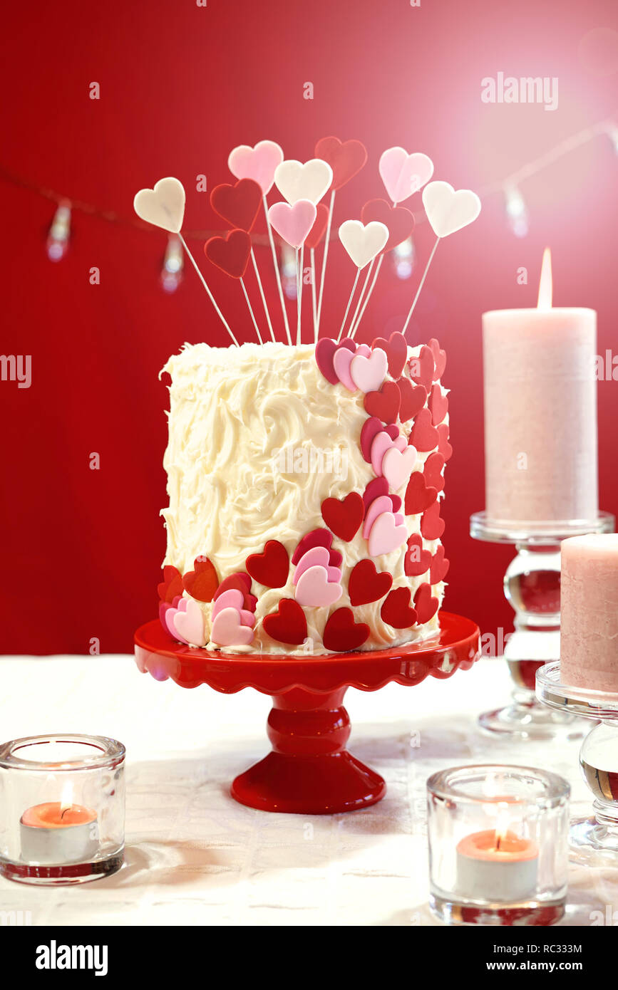 Belle St Valentin Partie Table Avec Showstopper Rouge Blanc Et Coeurs Roses Gateau Double Couche Avec Glacage Au Chocolat Blanc Avec Des Reflets Photo Stock Alamy