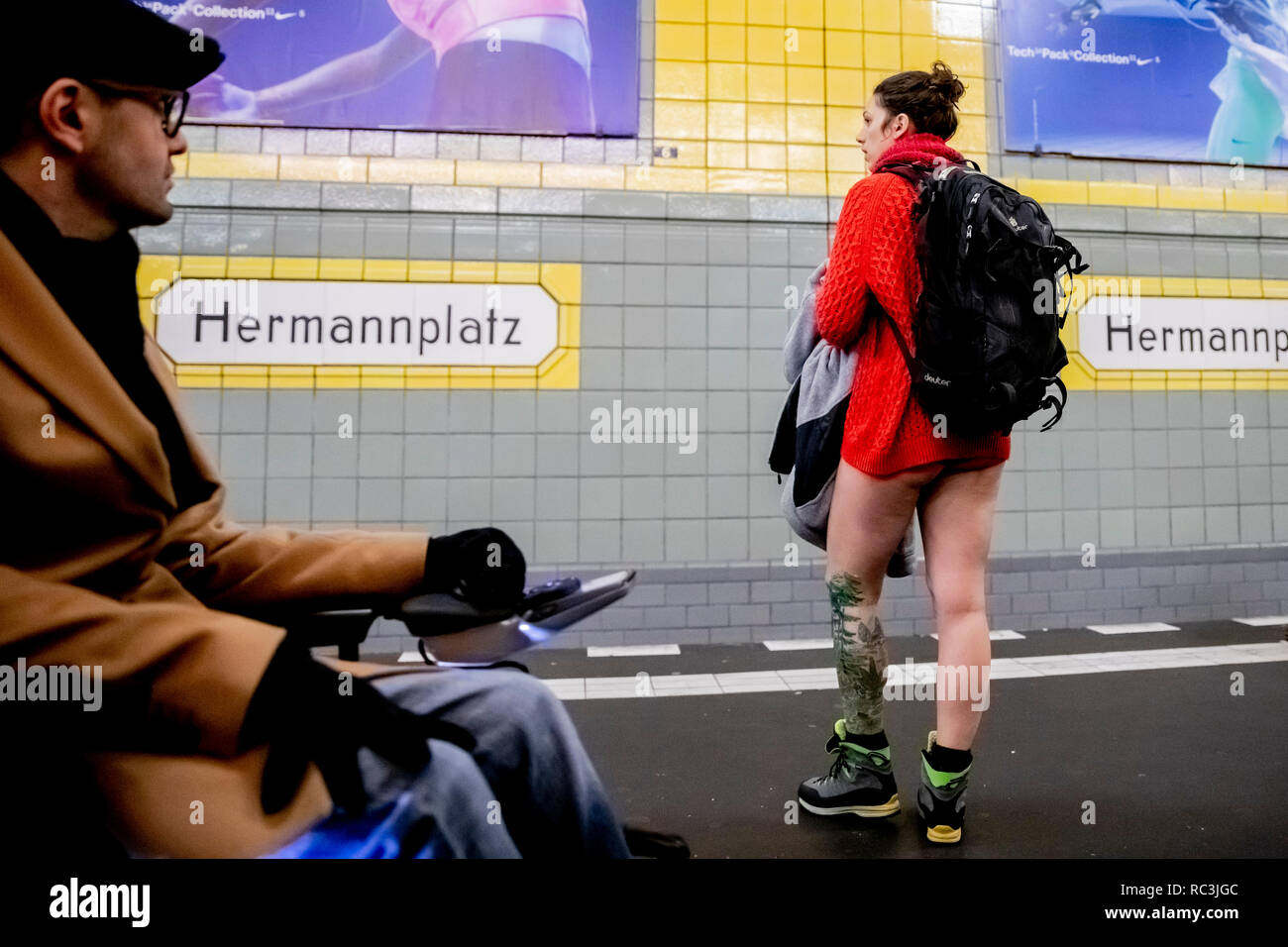 Berlin Allemagne. 13 Jan 2019. Un participant de l action No Pants Subway Ride est debout dans son calecon a la station de metro Hermannplatz tandis qu un homme en fauteuil roulant est la
