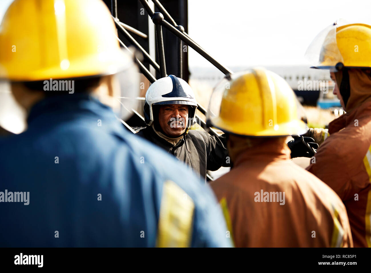 La formation des pompiers, les pompiers à l'écoute de superviseur, sur l'épaule Banque D'Images