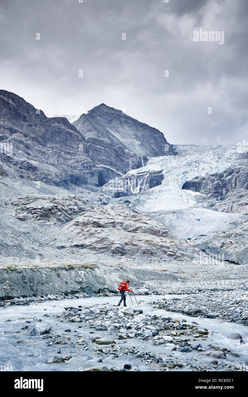 Randonneur traversant les terrains rocheux, le Mont Cervin, Matterhorn, Valais, Suisse Banque D'Images