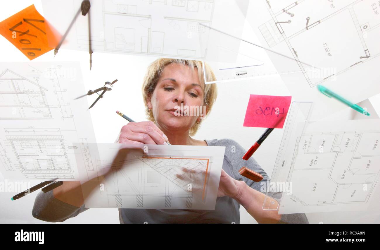 L'architecte travaille sur un plan de construction sur une table Banque D'Images