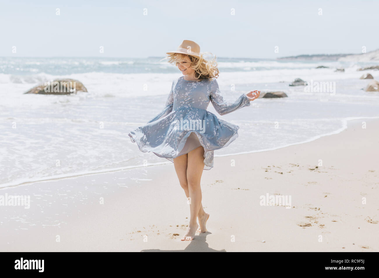 Jeune femme dansant sur la plage venteuse, Menemsha, Martha's Vineyard, Massachusetts, USA Banque D'Images