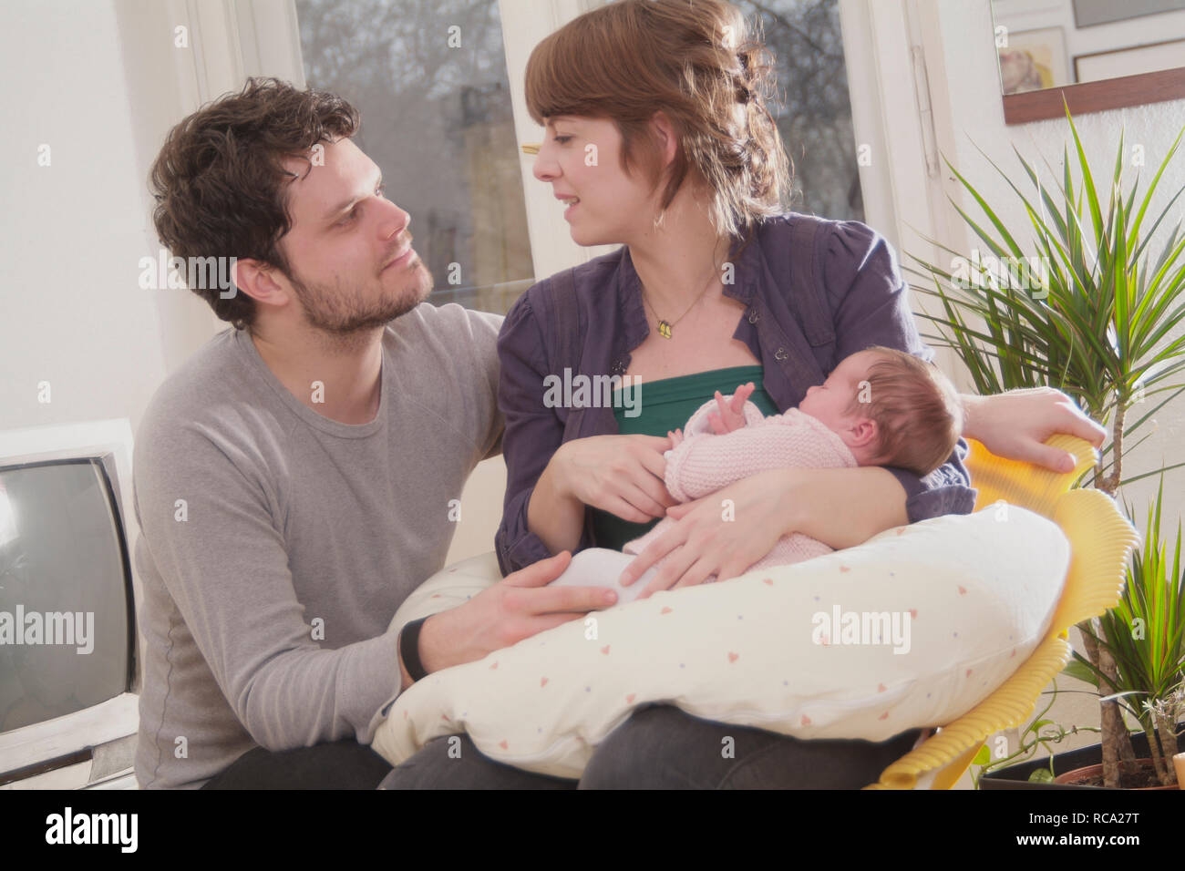 Junge Die Eltern halten ihre Tochter neugeborene im Arm, das ist genre 12 Tage alt | jeunes parents tenant son bébé nouveau-né dans ses bras - le bébé 12 ist Banque D'Images