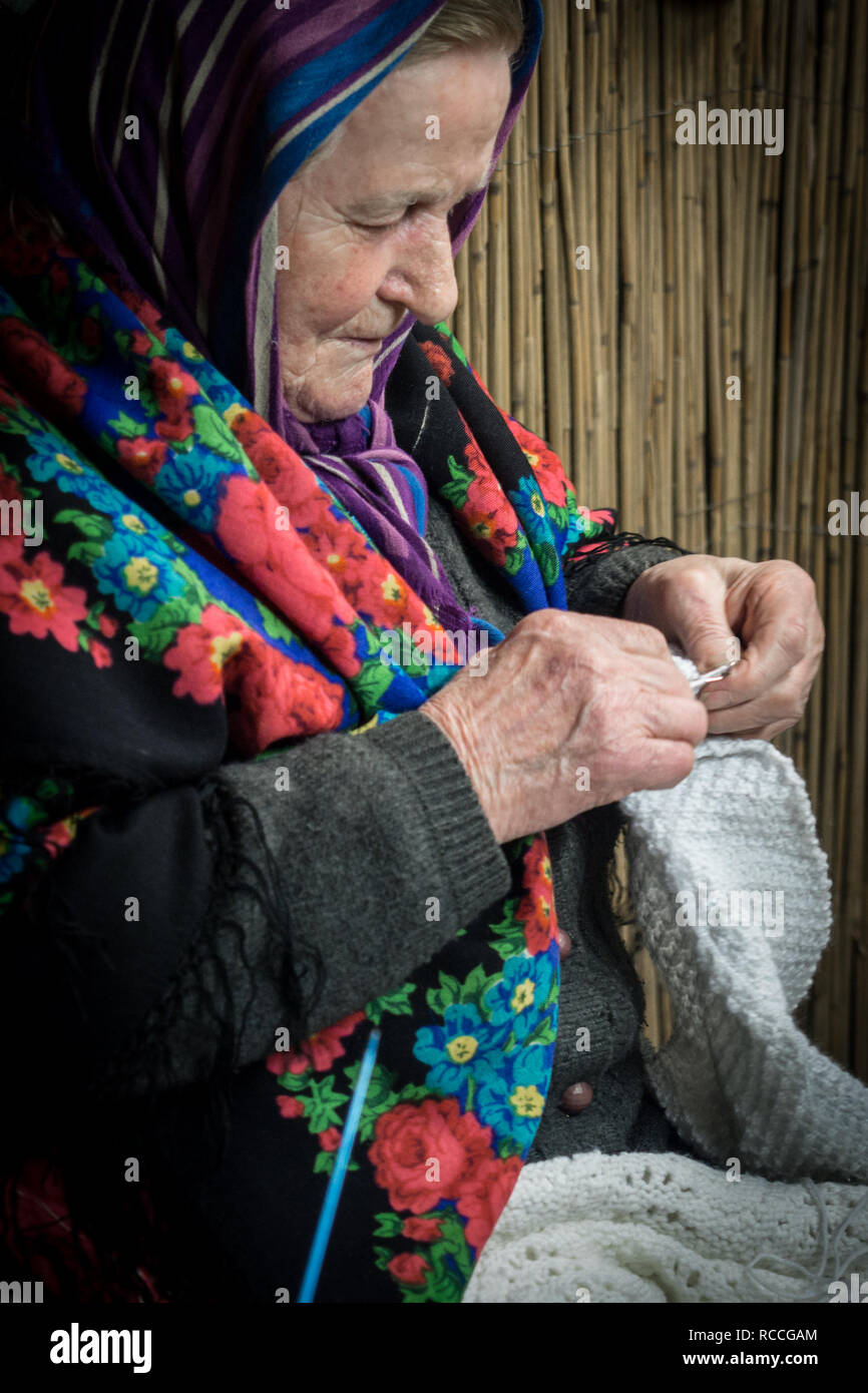 Vérone, Italie - le 26 décembre 2018 : Détail d'une vieille dame tricotant une couverture de laine. Banque D'Images