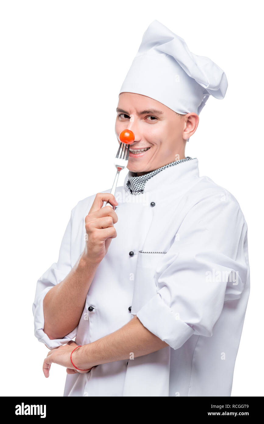 Cuisine avec tomate cerise sur une fourchette, tourné sur un fond blanc dans le studio Banque D'Images