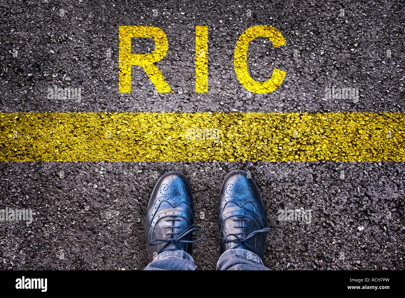 Chaussures et RIC (mot signifiant le référendum à l'initiative du citoyen) sur fond d'asphalte Banque D'Images