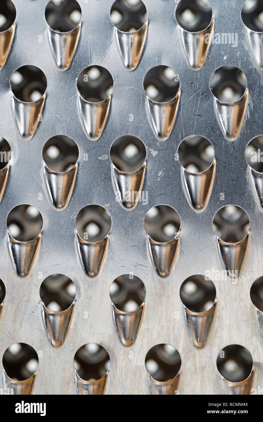 Râpe à fromage en métal, macro fond texture d'une image Banque D'Images