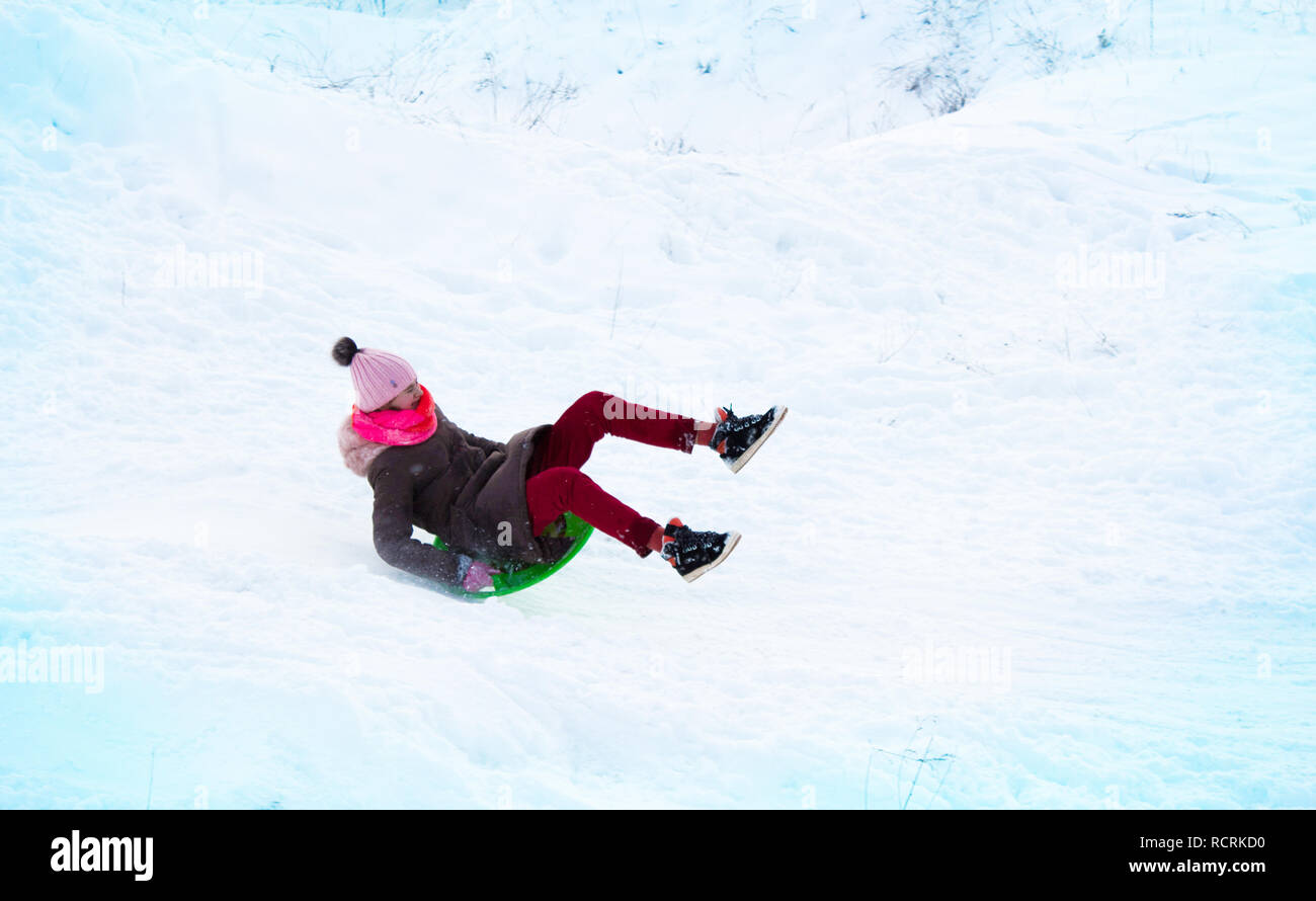 Girl vole sur une diapositive à partir d'une colline de glace Banque D'Images