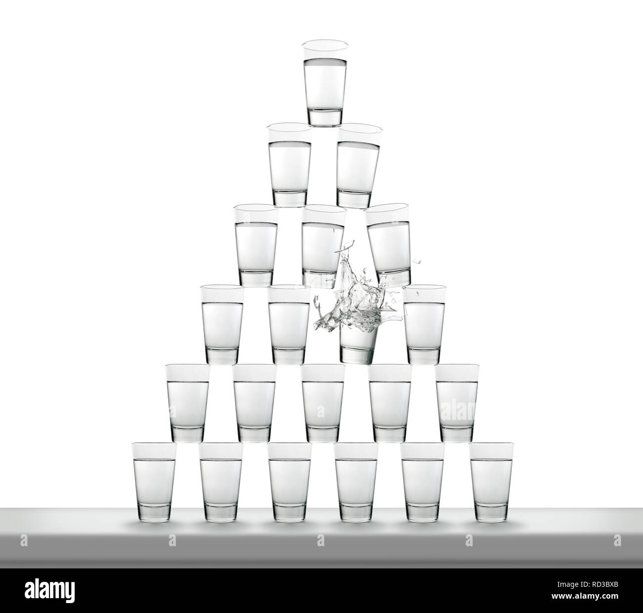 Pile de verres remplis d'eau en forme de pyramide avec des bris de verre. Banque D'Images