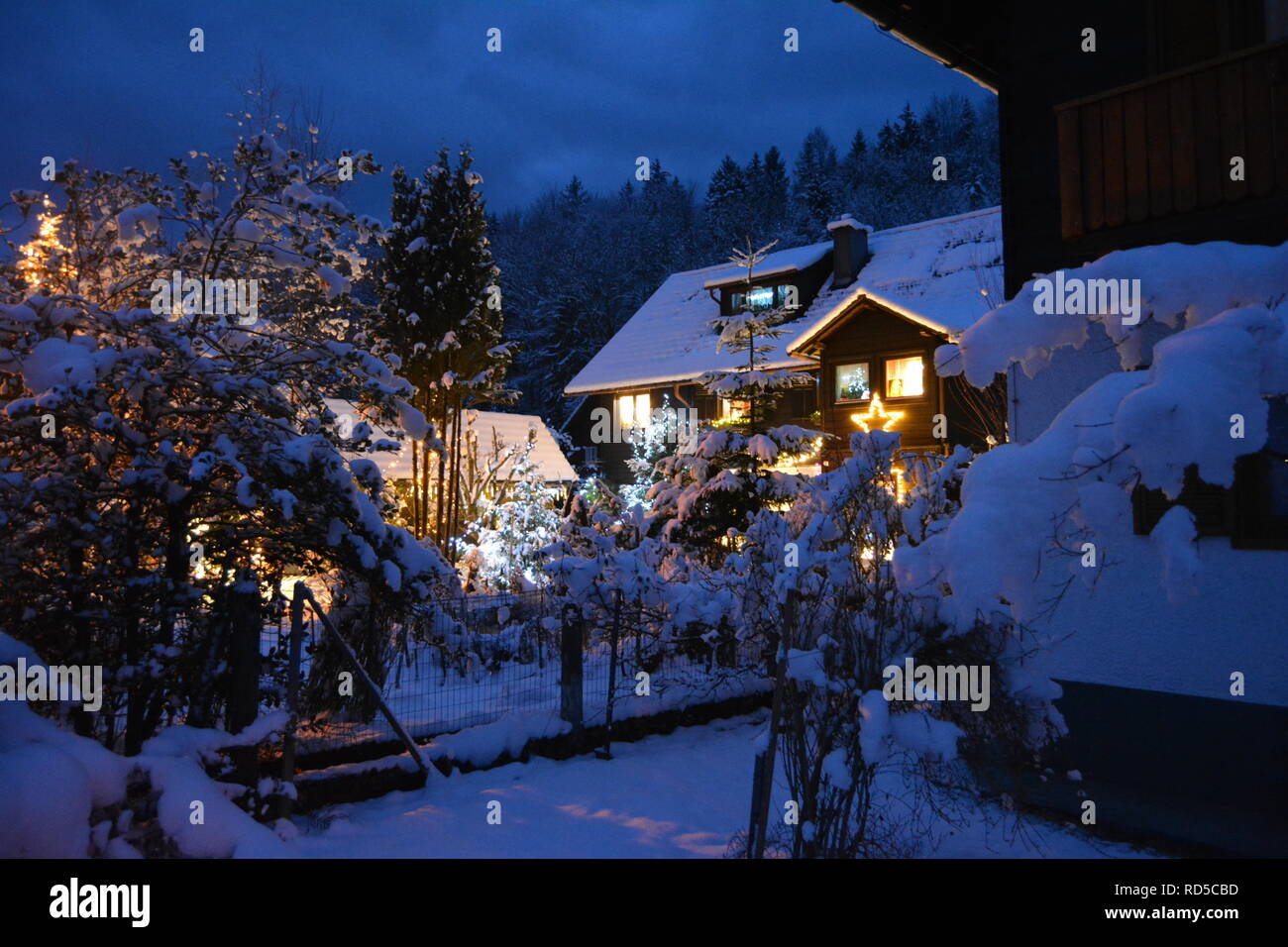 Petite maison couverte de neige et de feux d'chtistmas dans le pittoresque Bad Goisern, Hallstatt. L'Autriche. La tombée de la vue. Banque D'Images