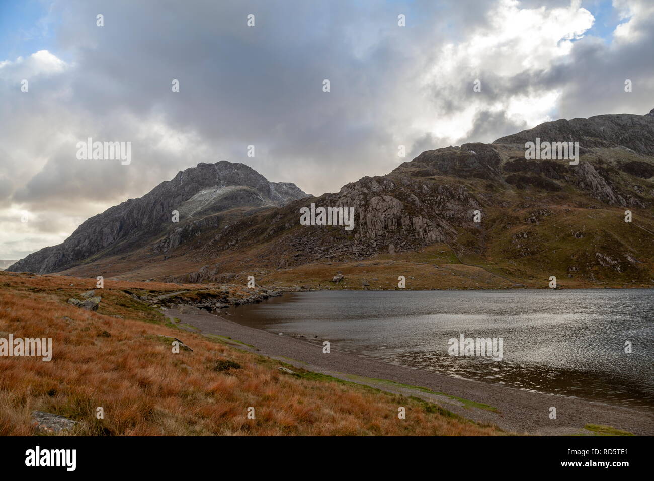 Faible neige couvre le sommet de Tryfan. Vue des rives du Llyn Idwal, Parc National de Snowdonia Banque D'Images