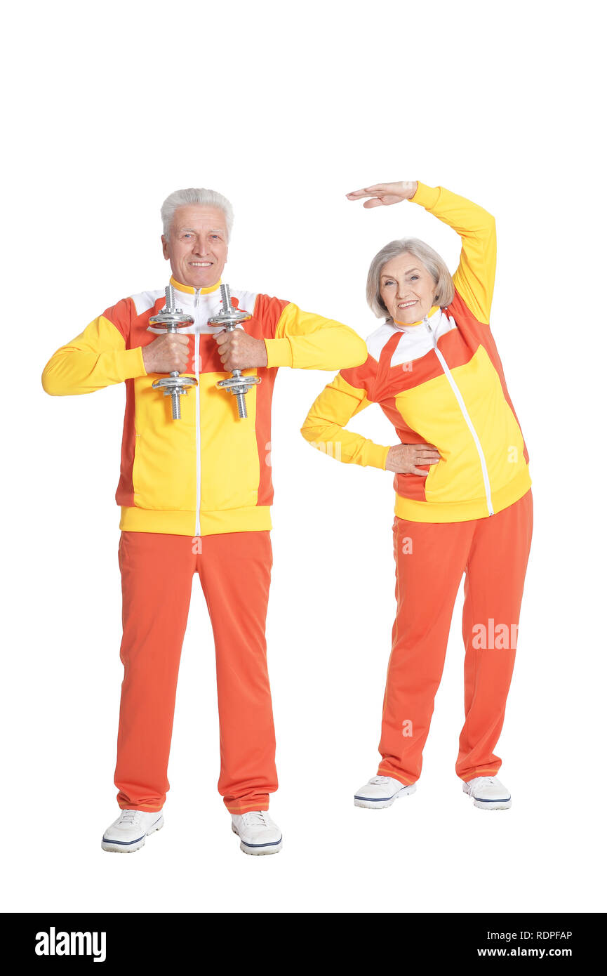 Portrait of smiling senior couple exercising active isolated on white Banque D'Images