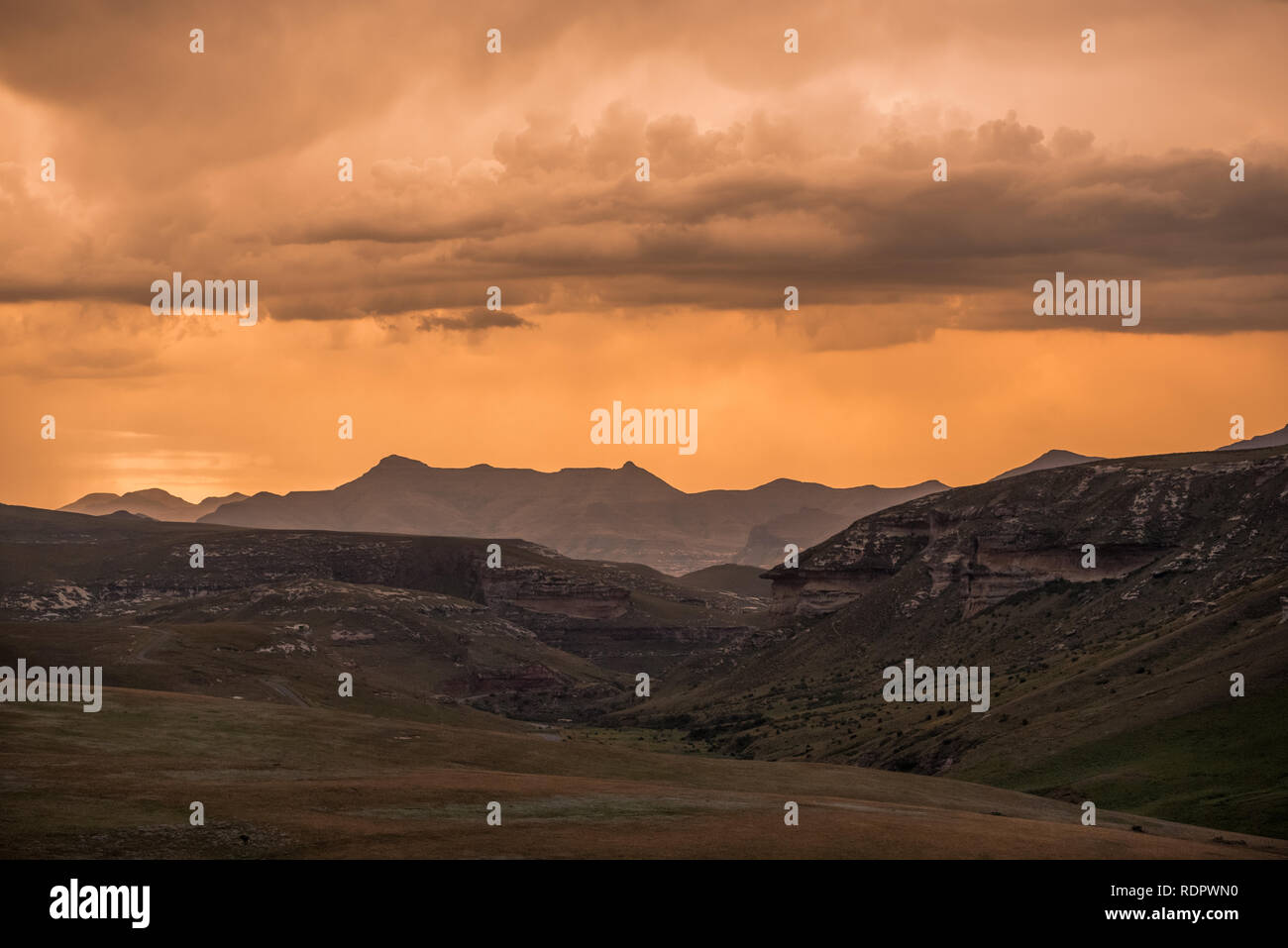 Nuages de tempête dramatiques or au coucher du soleil sur les montagnes du Drakensberg entourant l'Amphithéâtre, vu de Golden Gate Highlands National Park i Banque D'Images