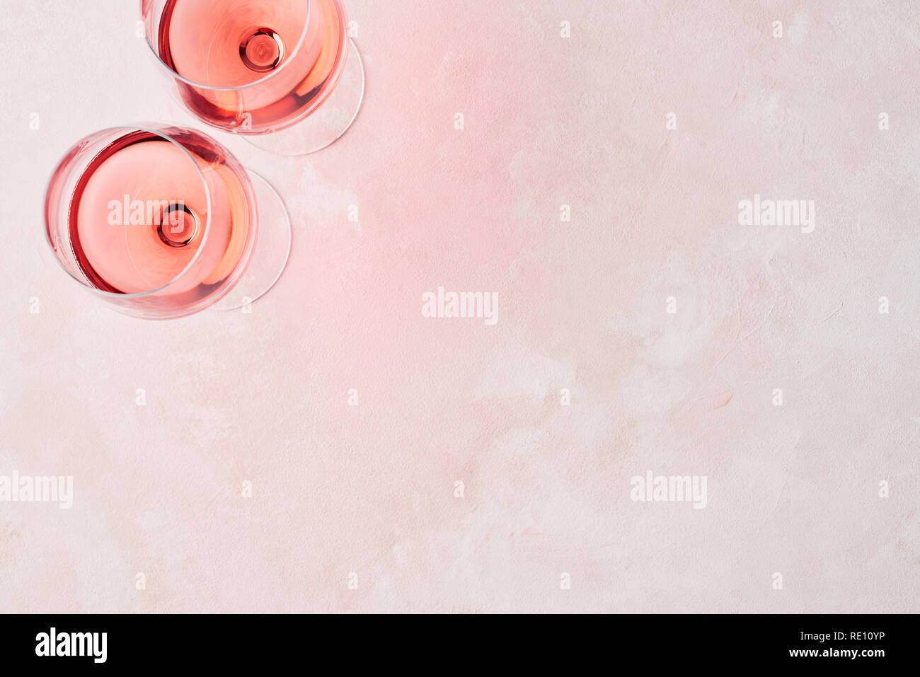 Boisson d'été. Verre de vin rose sur fond rose avec copie espace pour le texte. Vue d'en haut. Banque D'Images