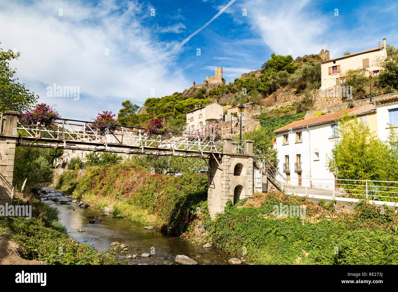 Pont sur ruisseau pittoresque à Lastours, France avec les châteaux dans la distance. Banque D'Images
