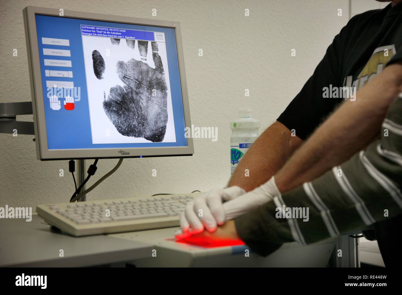 Les empreintes digitales et empreintes de mains est enregistré par scanner numérique, identification physique d'un suspect dans une enquête criminelle Banque D'Images
