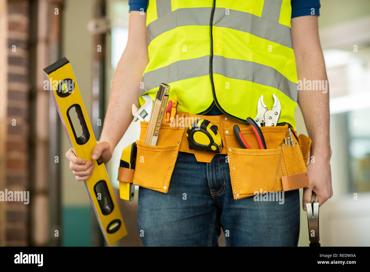 Détail de l'Ouvrier de la construction sur chantier Wearing Tool Belt Banque D'Images
