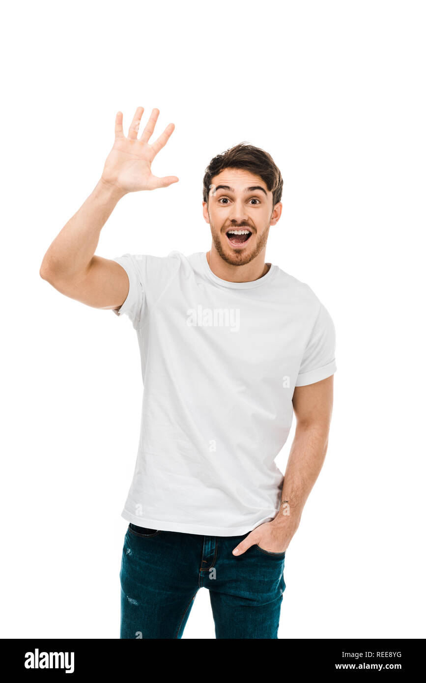 Cheerful young man waving hand and smiling at camera isolated on white Banque D'Images