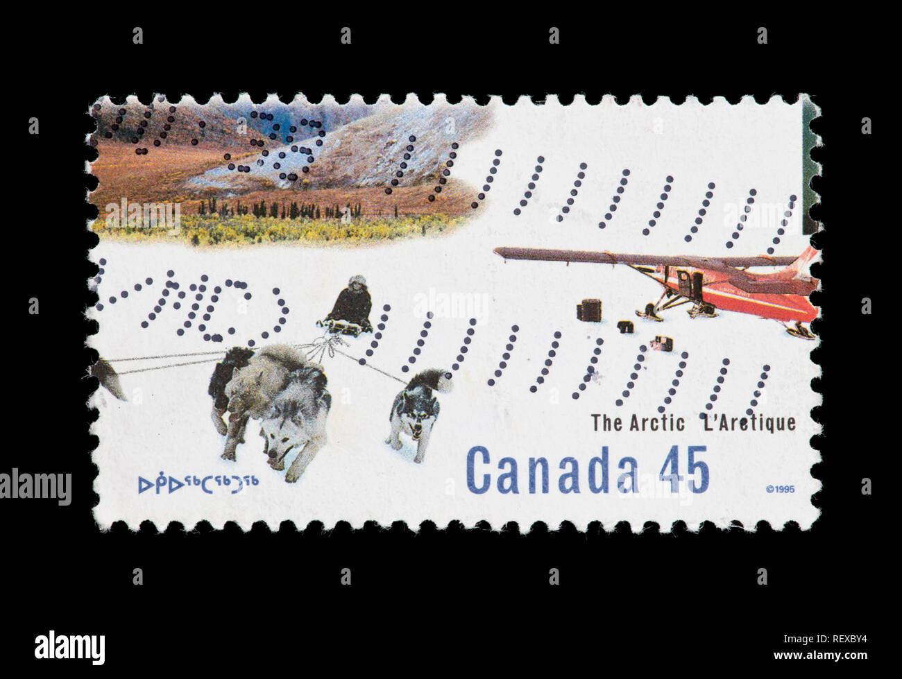 Timbre du Canada représentant une équipe de chien de traîneau et un avion sur ski Banque D'Images