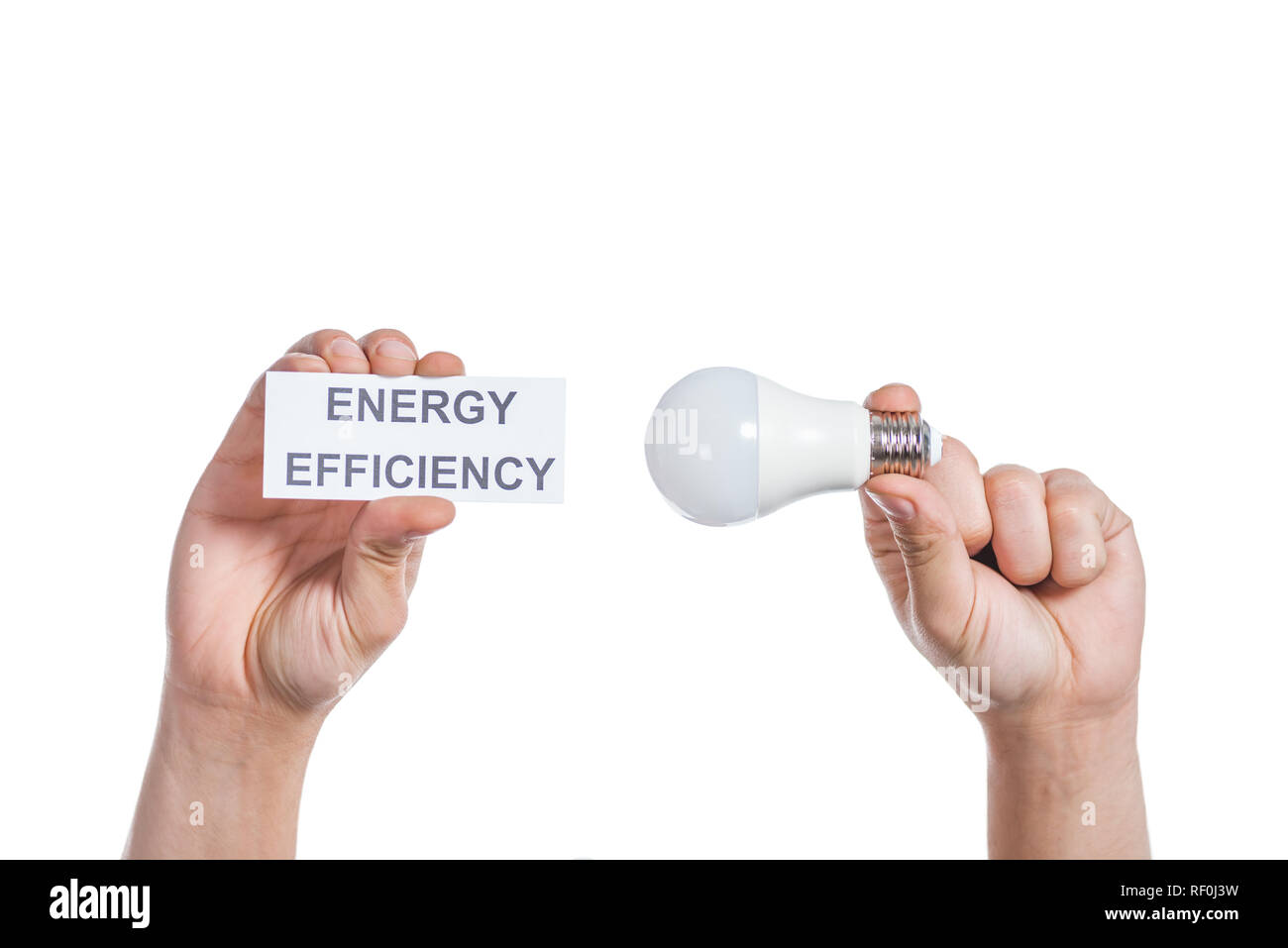 Portrait de male hands holding fluorescente et carte papier avec lettrage isolé sur blanc, concept d'efficacité énergétique Banque D'Images