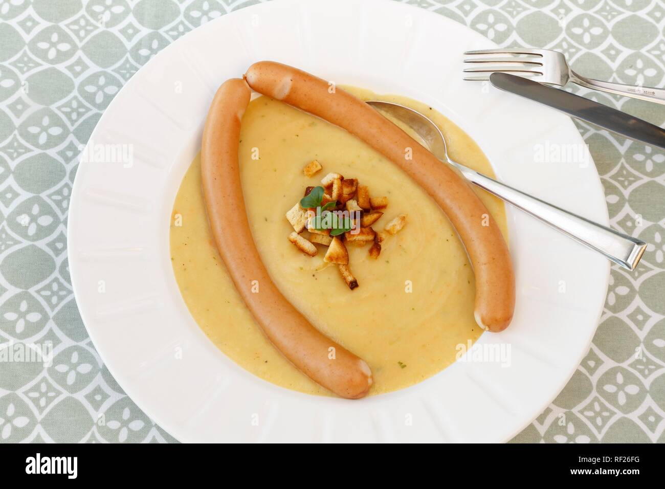 Une cuisine du sud de l'Allemagne, soupe de pommes de terre, croûtons, string saucisses, assiette, couvert, cuillère à soupe, couteau, fourchette, Allemagne Banque D'Images