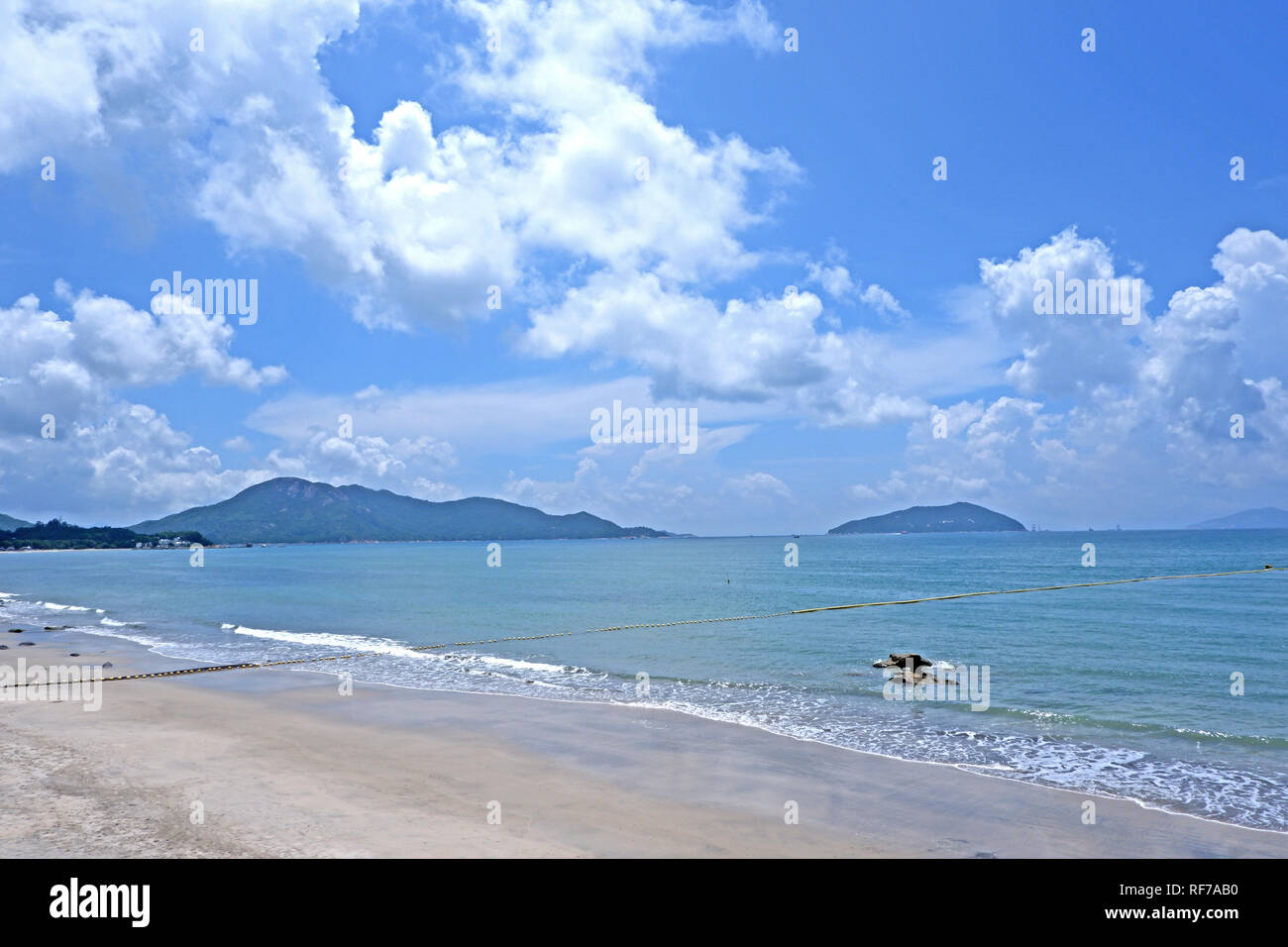 Le ciel bleu, blanc, montagne, nuage océan plage avec des vagues Banque D'Images