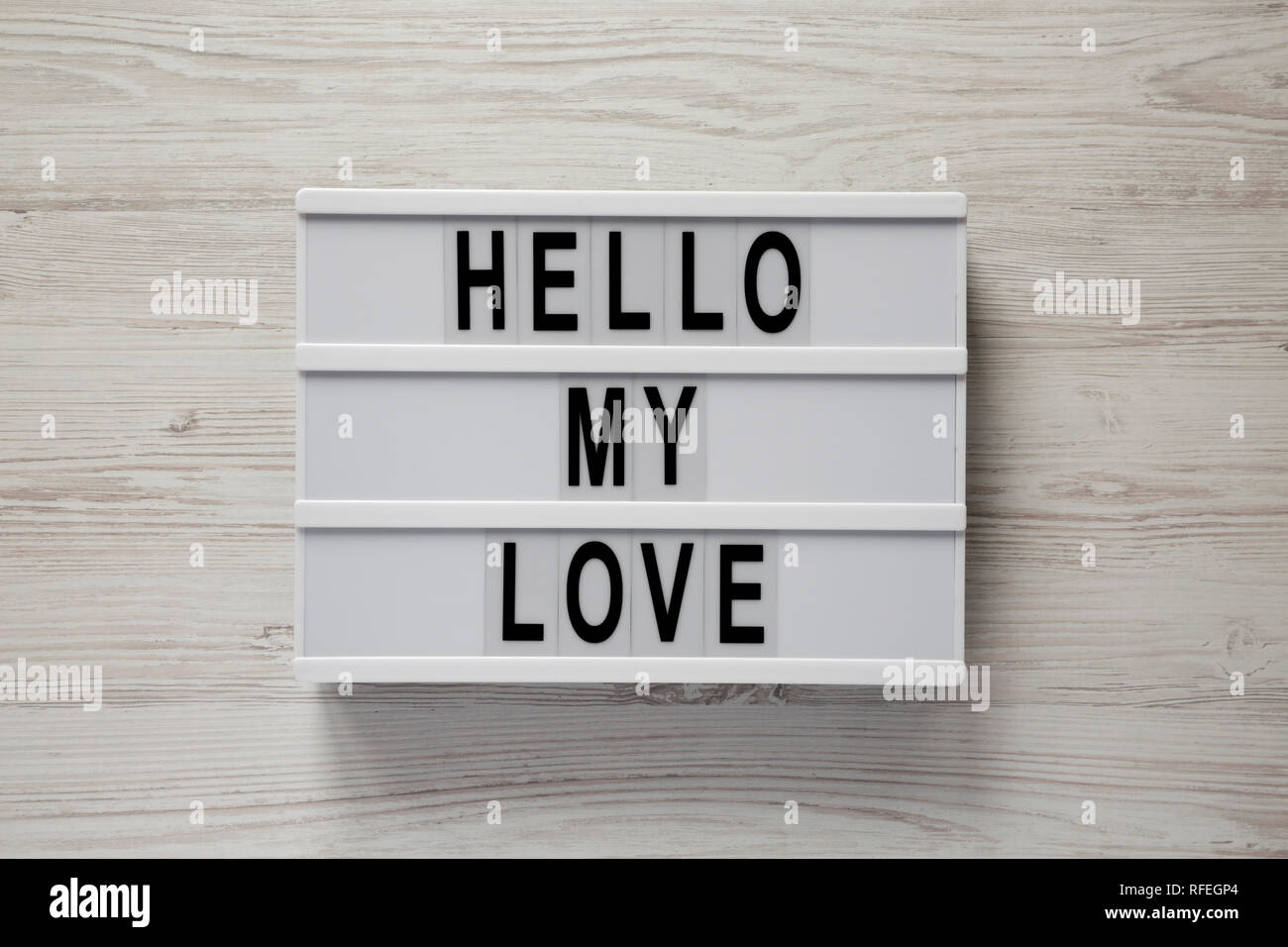 Conseil moderne avec le texte "Bonjour mon amour" sur un fond en bois blanc, vue du dessus. Valentine's Day 14 février. Close-up. Banque D'Images