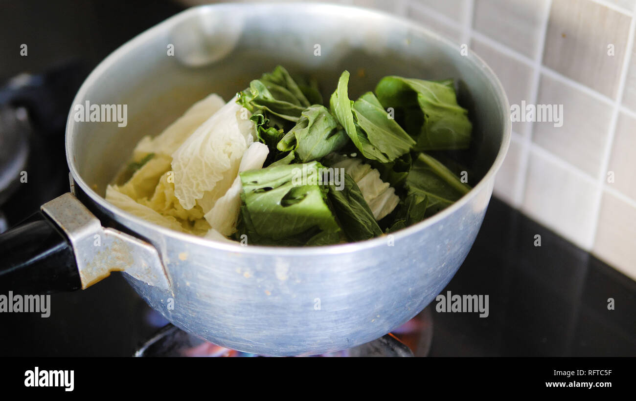 Soupe aux légumes de cuisson et cuire les légumes dans une casserole Banque D'Images