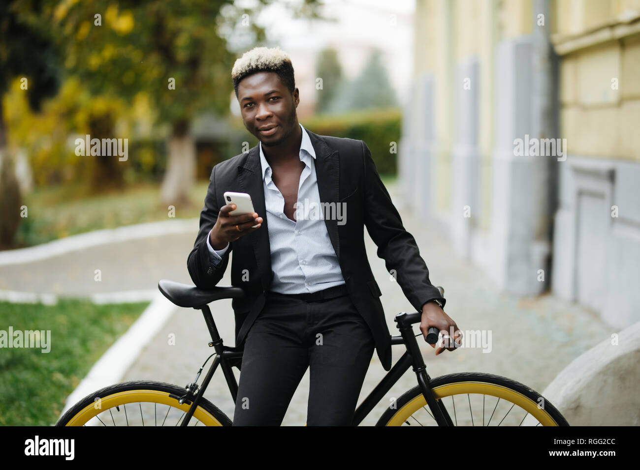 Homme Hipster avec location de l'envoi de message sur téléphone mobile en milieu urbain ville Banque D'Images