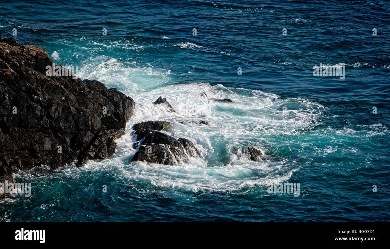 Se briser sur des rochers dans la mer Baye de la Forge sur la côte sud de Guernsey, Channel Islands Banque D'Images