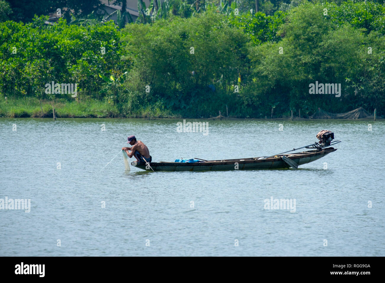 Pêcheur vietnamien sur un petit bateau de pêche sur la rivière des Parfums à Hue, VIetnam, Asie Banque D'Images