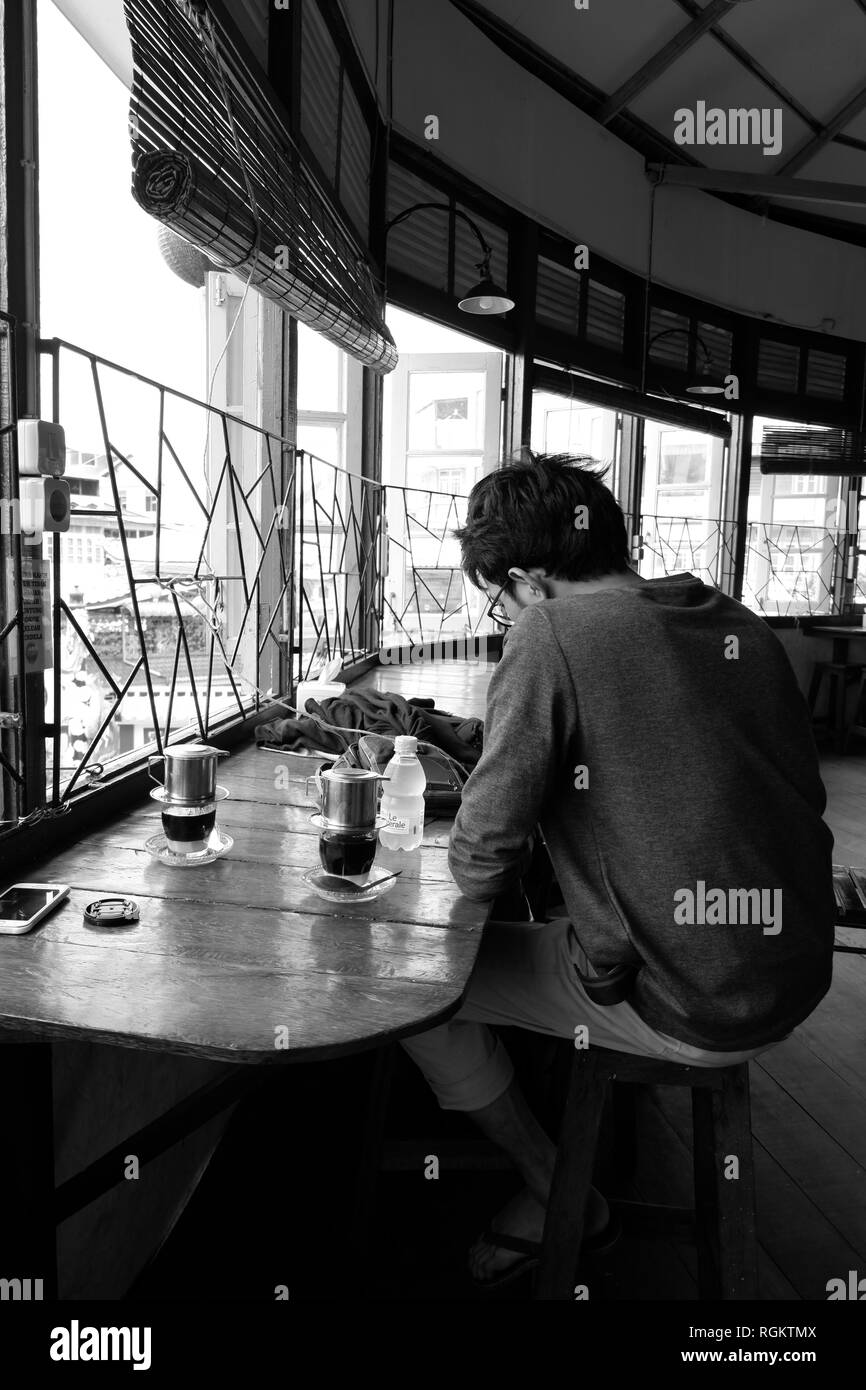 Bénéficiant d''homme seul café vietnamien traditionnel Banque D'Images