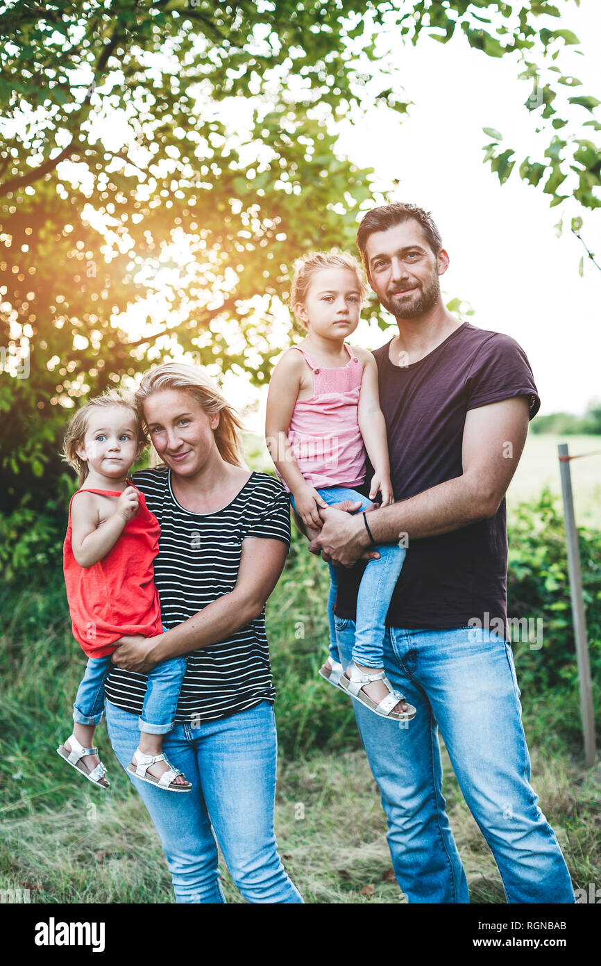 Portrait of smiling family avec deux filles debout dans la nature Banque D'Images