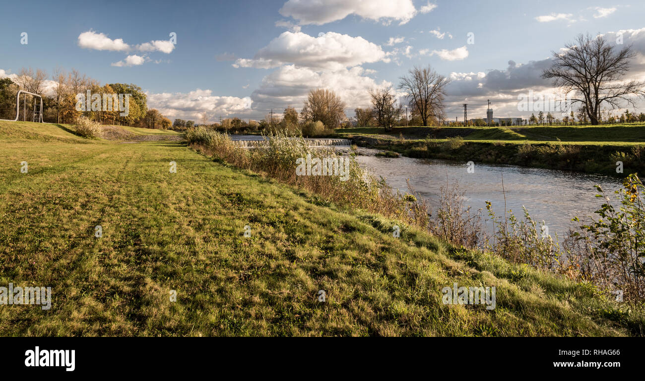 Beau décor de l'automne de la rivière Olse, arbres colorés, d'herbe et de ciel bleu avec des nuages dans la ville de Karvina en République Tchèque Banque D'Images