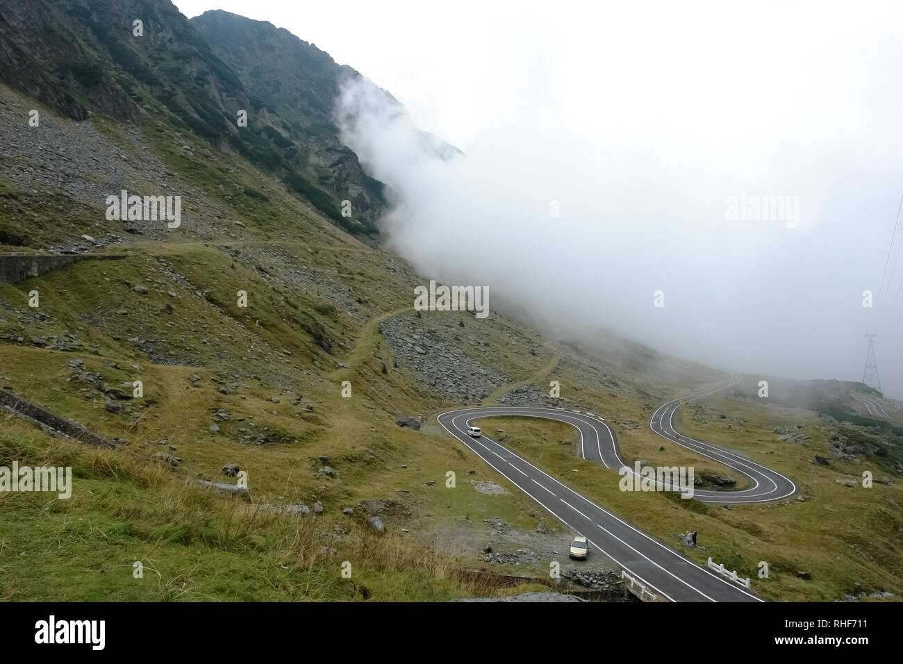 Nuage Blanc et scenic route de montagne sinueuse Transfagarasan dans les Carpates roumaines. Banque D'Images