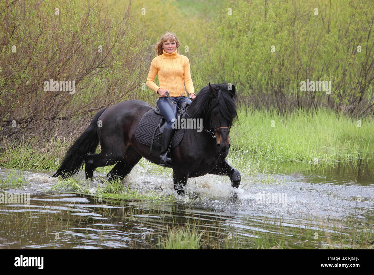 Les jeunes grâce à son cheval équitation cowgirl river Banque D'Images