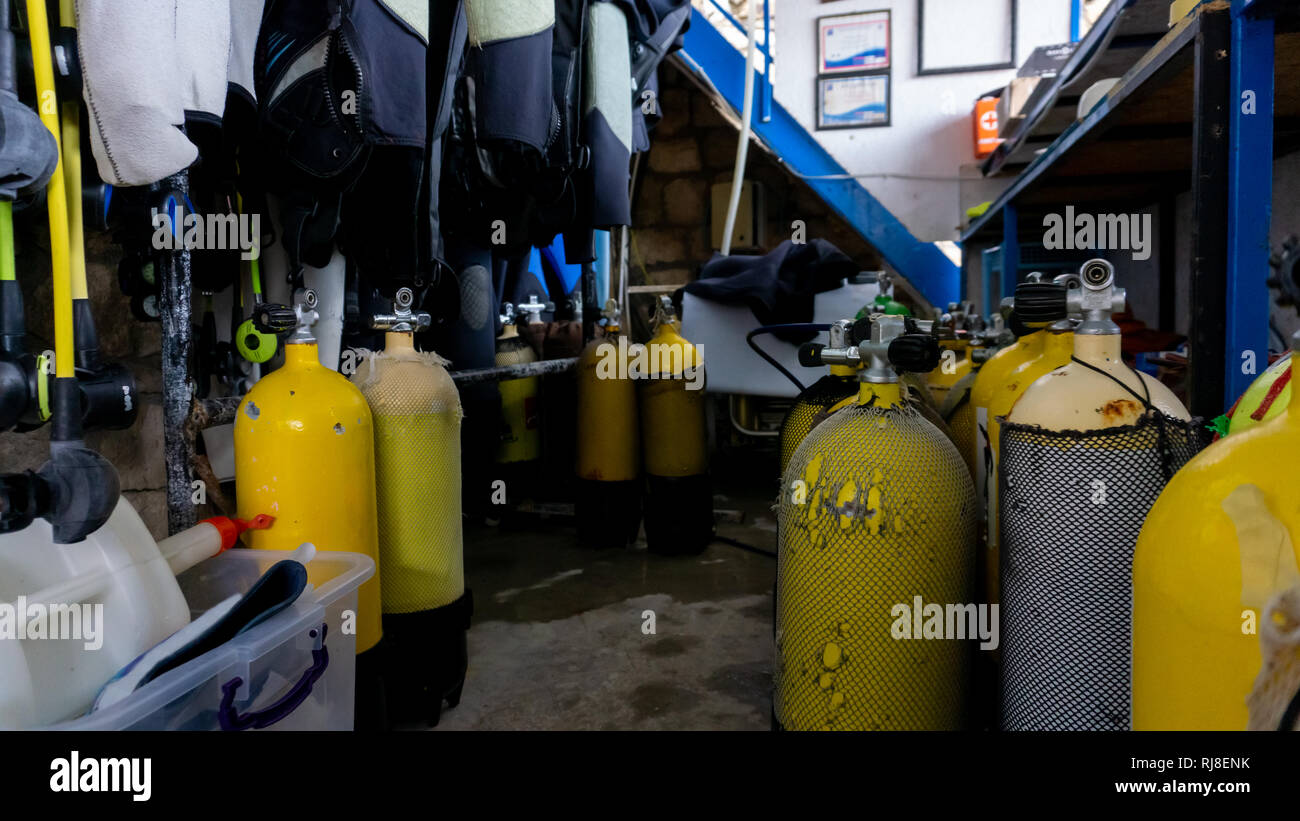 Stockage de plongée sous-marine, avec de nombreux réservoirs jaune d'oxygène dans un vieux store Banque D'Images