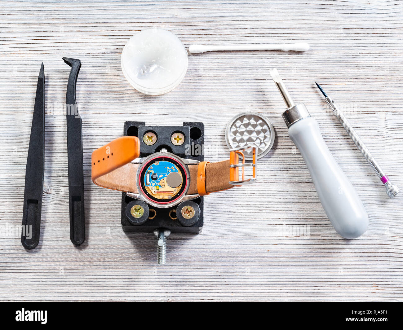 Atelier de réparateur watch - ensemble d'outils pour le remplacement de batterie montre-bracelet quartz sur table en bois Banque D'Images