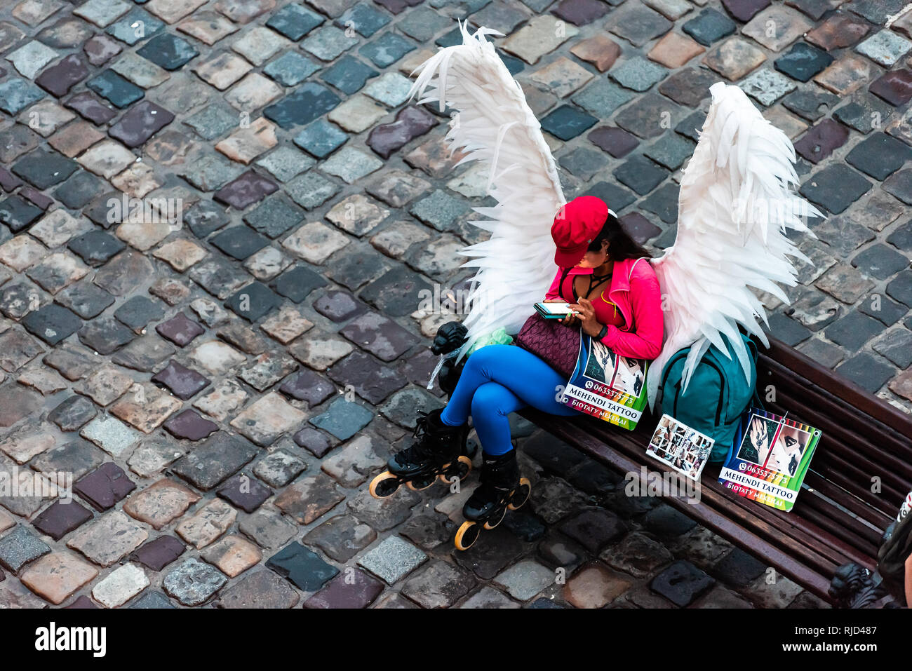 Lviv, Ukraine - le 31 juillet 2018 : high angle au-dessus de la place du marché de la vieille ville et la femme d'ailes d'Ange assis sur le banc de la publicité pour tatouage Banque D'Images