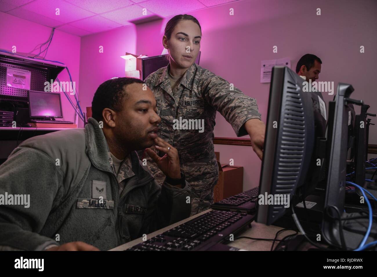 Rimer ou ramer Miller Navigant de première classe et d'un membre de la 1re classe Amanda Bouton, 707e Escadron des communications techniciens système client, mettre à jour des logiciels pour les ordinateurs qui seront utilisés sur les réseaux de l'Armée de l'air le 9 janvier 2018 à Fort George G. Meade, Maryland. Le 707e CS, aligné sous la 70e Renseignement, Surveillance et Reconnaissance Wing, prend en charge plus de 5 700 membres du personnel international et 57 missions de l'Agence de sécurité nationale avec leurs 230 'Thunder guerriers." Banque D'Images