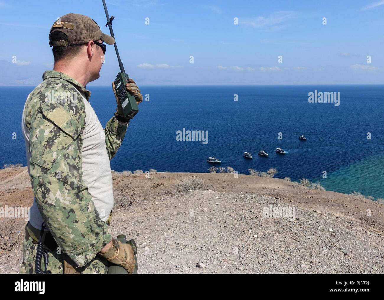 Golfe de Tadjourah, Djibouti (janv. 17, 2018) officier de sécurité du tir, premier maître de Manœuvre Scott Tatum, affecté à l'Escadron fluviales côtières (CRS) 10, les montres comme patrouille tactique de la ligne de l'artisanat pour une arme à feu en cours tirer en l Golfe de Tadjourah, à Djibouti. Le CS Ex-10 est l'avant-déployés aux États-Unis 6e zone d'opérations de la flotte et mène des opérations navales et mixte, souvent de concert avec les pays alliés et partenaires interinstitutions, afin de faire progresser les intérêts nationaux américains et la sécurité et la stabilité en Europe et l'Afrique. Banque D'Images