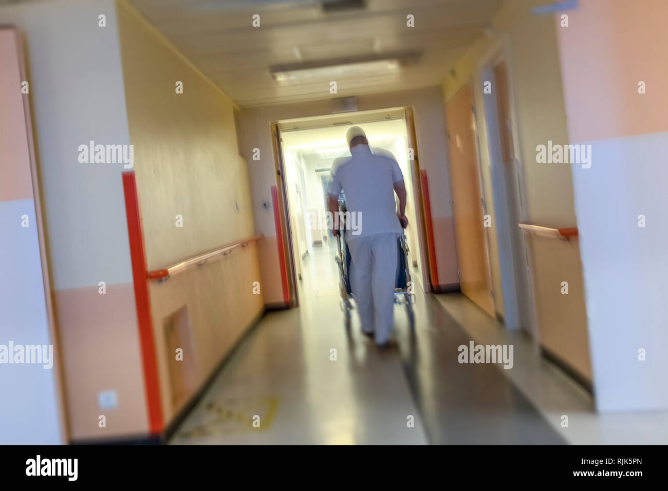 Dans un grand et long couloir infirmier l'phushing handicapé une persone Banque D'Images